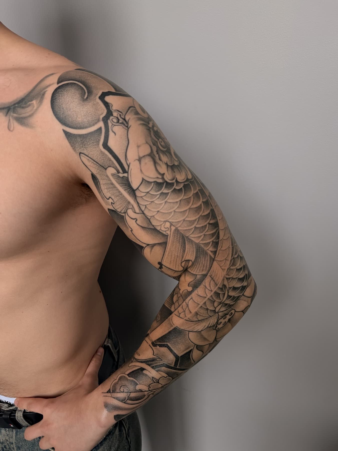 Black and grey sleeve tattoo in progress
