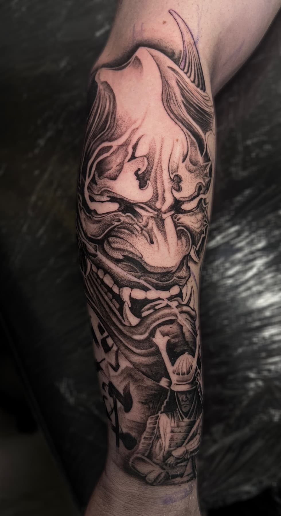 Detailed black and grey fantasy tattoo